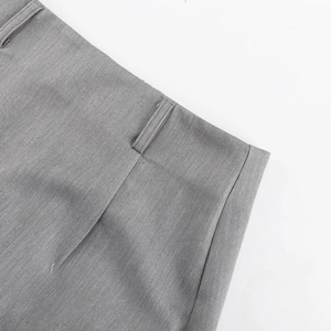 Detail view of high-waist grey fishtail skirt featuring precise stitching and belt loops