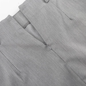 Detail shot of the invisible zipper and diagonal twill texture on a grey fishtail skirt