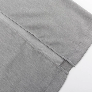 Detailed view of the grey fishtail skirt featuring a slit hem and neat stitching craftsmanship