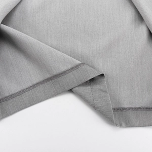 Detailed close-up of double-needle stitching and texture on grey fishtail skirt hem