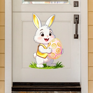 Detailed view of an Easter bunny wall decal holding a golden egg on a white door