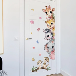 Detail of baby animal wall stickers with giraffe and elephant on a white wooden door