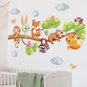 Detail of forest animal wall stickers set above a baby crib in a cozy nursery room