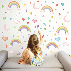 Detailed view of watercolor rainbow and star wall decals in a cozy children room setting