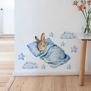 Detailed view of sleeping rabbit and luminous blue stars on nursery wall stickers
