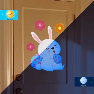 Luminous Easter bunny wall decal showing glowing blue egg and daisies in day and night
