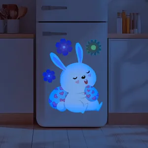 Luminous Easter bunny and floral wall stickers glowing blue in dark bedroom interior
