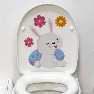 Detailed view of luminous Easter bunny and egg sticker applied on a white toilet lid