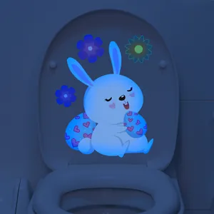 Glow-in-the-dark blue Easter bunny and floral wall sticker shown in a dark room setting
