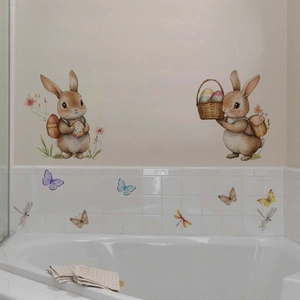 Detail of Easter bunny and butterfly wall stickers applied on white bathroom tiles