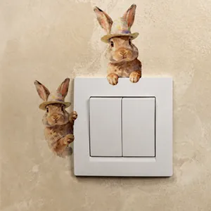 Detailweergave van 3D-stijl aquarellen konijnenstickers rond een witte wandschakelaar