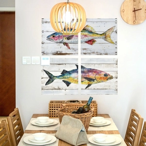 Detailed view of four-panel watercolor fish wall stickers with rustic white wood texture