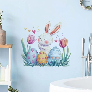 Easter wall decal detail showing watercolor rabbit and colorful eggs on a blue bathroom wall