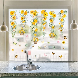 Window decals featuring yellow daisies, green vines, and butterflies on glass window