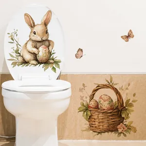 Detailed view of watercolor Easter bunny and egg stickers applied to a white bathroom surface