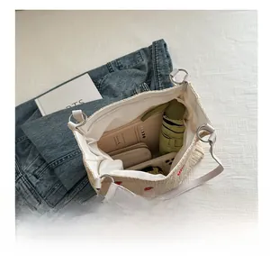 Internal view of beige woven bucket bag showing capacity for phone and umbrella