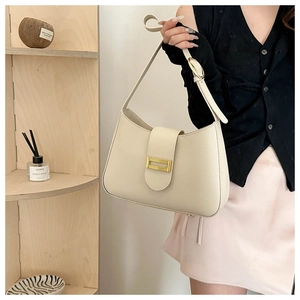 Detail of cream white faux leather shoulder bag with gold buckle and adjustable strap
