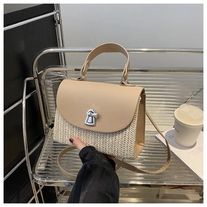 Detail der minimalistischen Stroh- und Lederhandtasche mit silbernem Drehverschluss