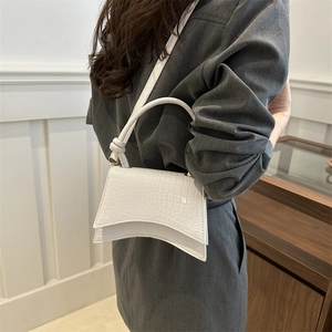 White crocodile pattern hourglass handbag with unique curved base and crossbody strap