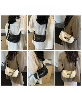 Detail of crescent crossbody tote bag with adjustable branded strap in black and cream
