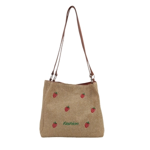 Strawberry embroidered straw bucket tote bag with brown shoulder straps for beach vacation