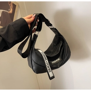 Close-up of black lychee grain leather crescent bag with logo strap and side tag
