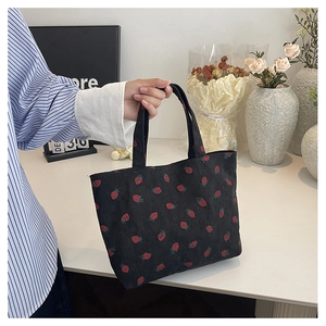 Detail of strawberry print corduroy tote bag showing its rich texture and large capacity