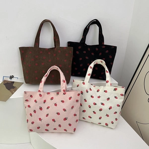 Corduroy tote bags with strawberry prints in brown, black, pink and white colors