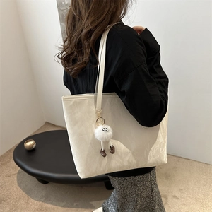 White textured tote bag with pleated design and charm for daily commute and shopping