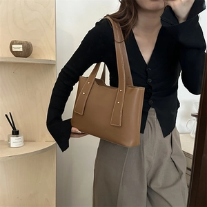 Brown PU leather tote bag with gold studs and top handles for casual daily use
