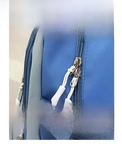 Detail of durable two-way metal zippers and adjustable buckles on the blue school backpack