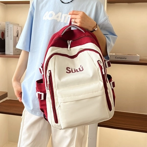 Detail showing the large capacity front pocket and SÜLÚ branding on the retro backpack