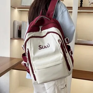 Side view of student vintage color-block backpack in burgundy and beige with buckle details