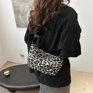 Vintage leopard print hobo shoulder bag with black strap and elegant gold hardware