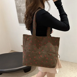 Large dark brown corduroy tote bag with strawberry embroidery and a simple shoulder strap