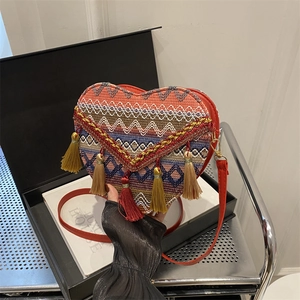 Ethnic heart-shaped crossbody bag with colorful embroidery and long red tassels