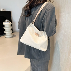 Minimalist beige corduroy tote bag for women showing a stylish shoulder bag look