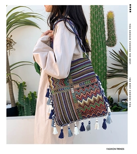 Detail of colorful bohemian woven tote bag with fringe tassels and zigzag pattern