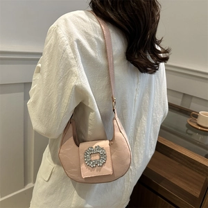 Pink crescent hobo bag with rhinestone square buckle and glossy pleated texture finish