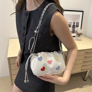 Mini white canvas bucket bag with colorful heart patches and silver chain strap for women