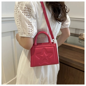 Detail of rose pink square bag with embossed stars and adjustable crossbody strap