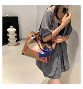 Detail of color-block tote bag with geometric design worn with casual outfit
