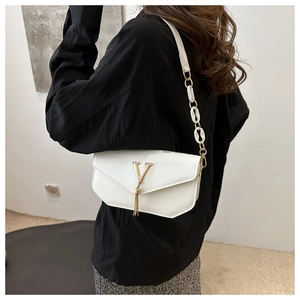 White crossbody shoulder bag for women, stylish small square bag with gold V logo and tassel.