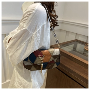 Stylish patchwork leather shoulder bag with chic metal V clasp and tassel for daily commute.