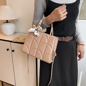 Quilted beige tote bag with chic printed scarf handle for stylish women daily use