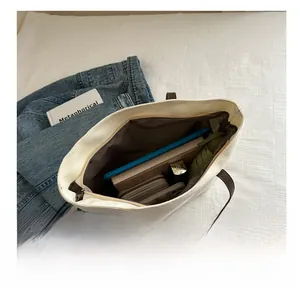 Spacious tote bag interior showcasing items like a tablet, umbrella, and wallet for daily use