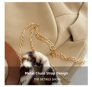 Detail of premium golden hardware chain strap and leopard print plush fabric on bucket bag