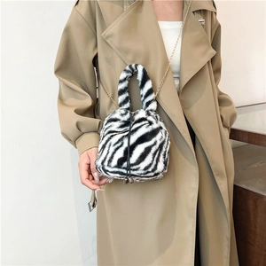 Plush zebra print bucket bag with gold chain strap and drawstring closure for women