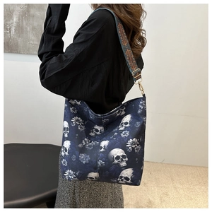 Detail of wide ethnic embroidered strap and skull floral print on canvas tote bag