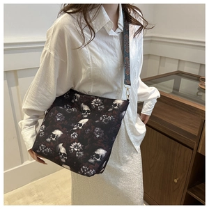 Detail of gothic skull and purple floral canvas tote with jacquard shoulder strap